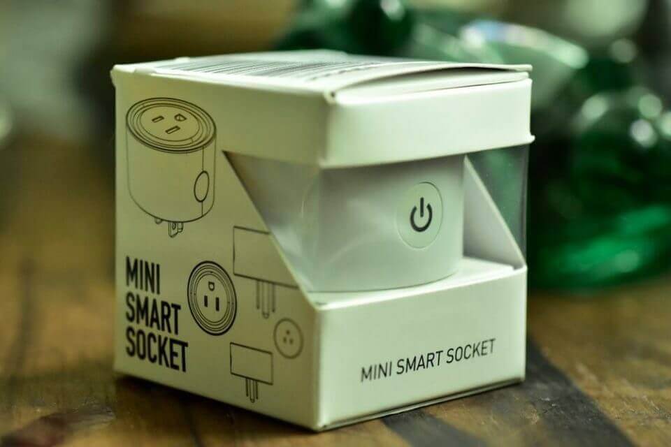 A mini smart socket for starting smart home automation with Alexa in the Philippines is sitting on top of a table.