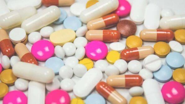 A pile of pills and capsules on a white surface in Metro Manila.