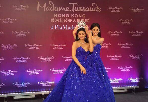 Two women, Catriona Gray and Mak Tumang, wearing blue gowns, pose for a photo.