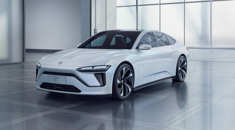 A NIO electric car is shown in a white room.