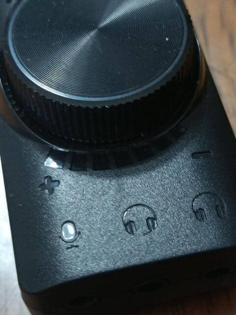 A close up of a black device with buttons on it, the Plextone GS3 Virtual 7.1 Channel USB Sound Card.