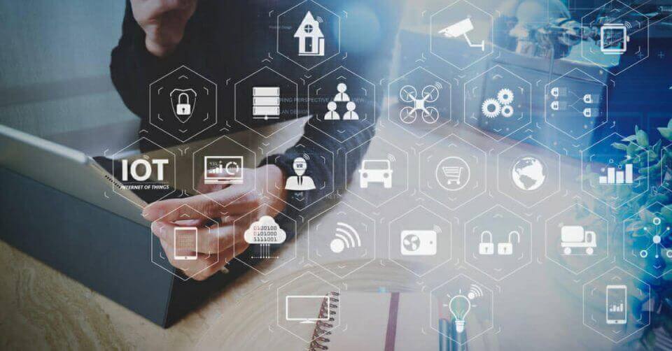 A person streaming movies on a laptop with IoT icons, showcasing the best VPN for 2021.