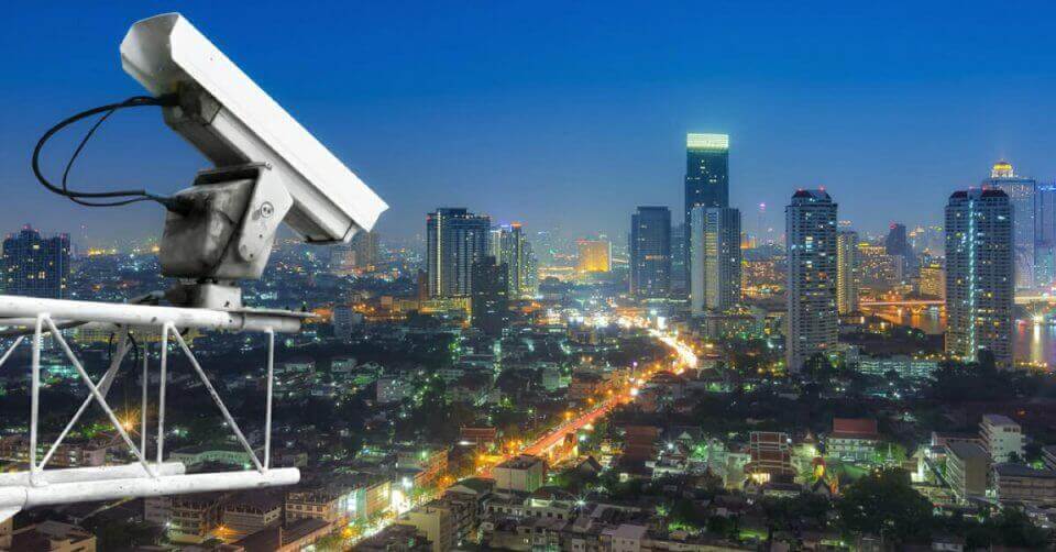 A city at night captured by a CCTV camera.