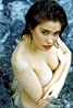 A woman in a bathing suit posing in the water for a regal entertainment film.