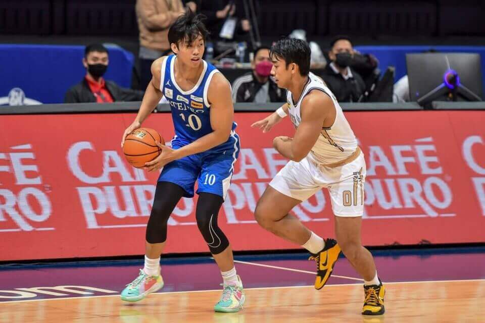 A basketball player dribbles the ball on a court, representing Ateneo Blue Eagles.