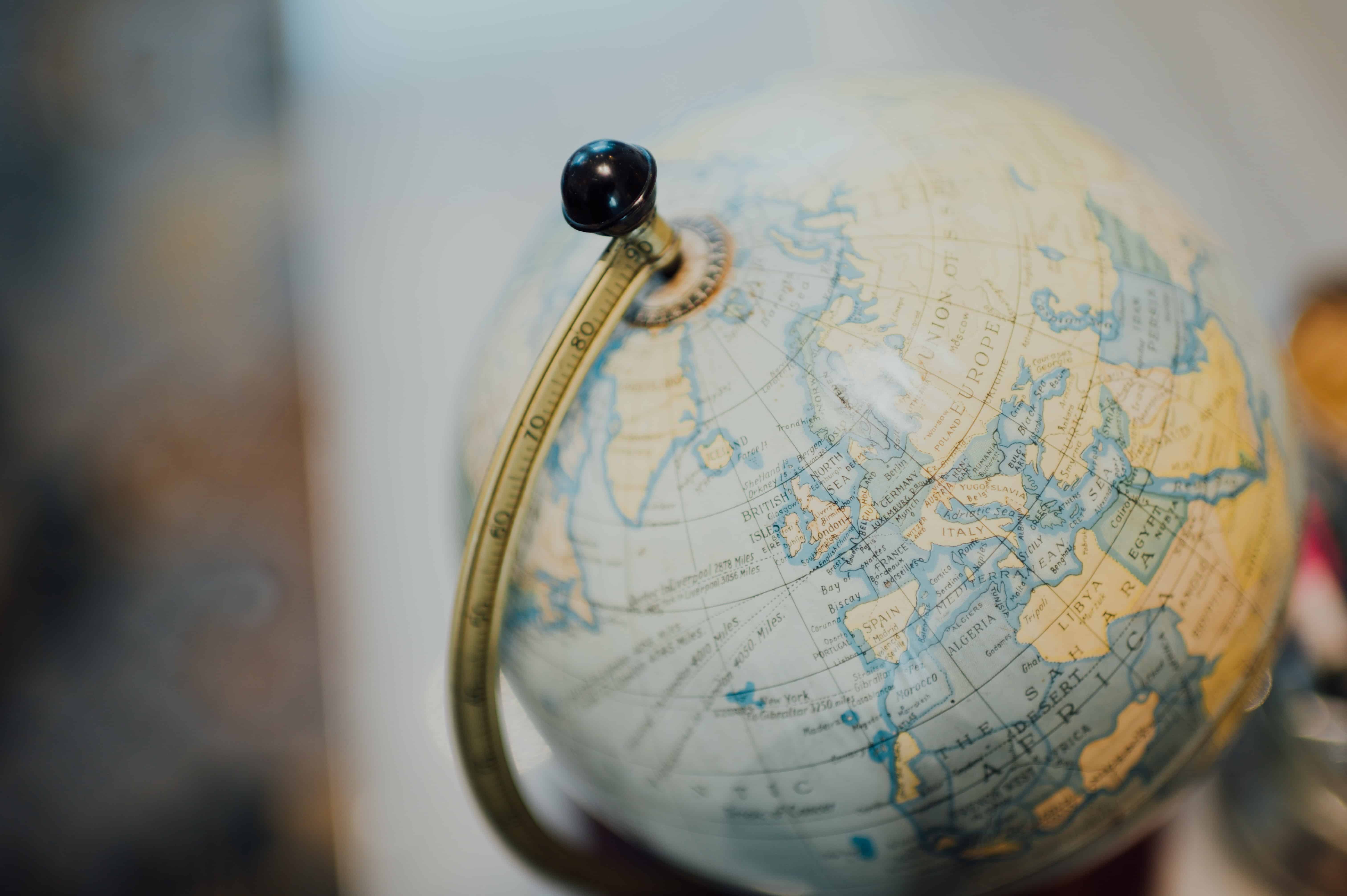 Close-up of a GLOBE™ showcasing Europe, Asia, and Africa with a brass meridian.