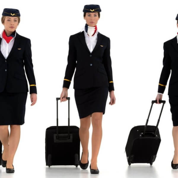 A group of Philippines airline attendants with luggage.