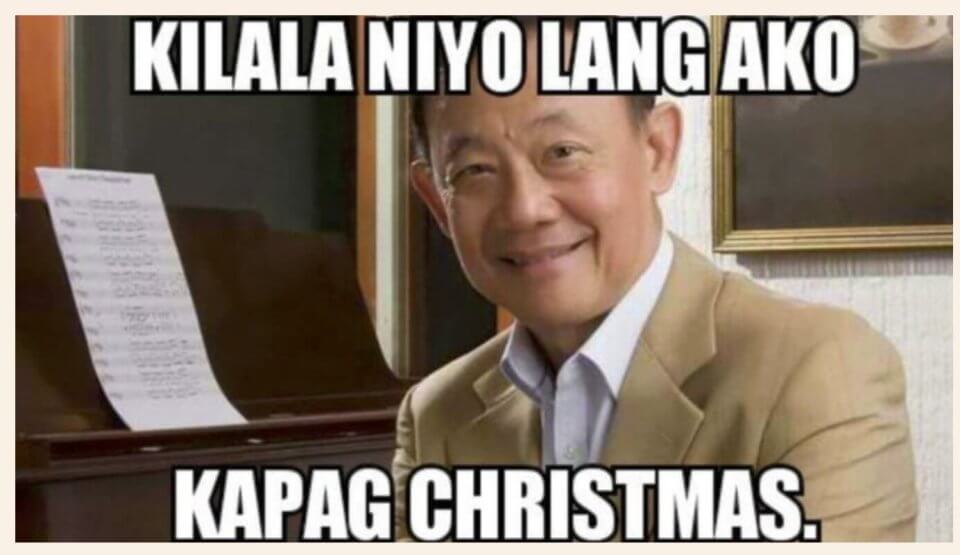 A smiling man in a beige suit sits beside an upright piano with sheet music. Text above reads "KILALA NIYO LANG AKO," while below it says "KAPAG CHRISTMAS," humorously nodding to Jose Marie Chan's meme-worthy holiday appeal.