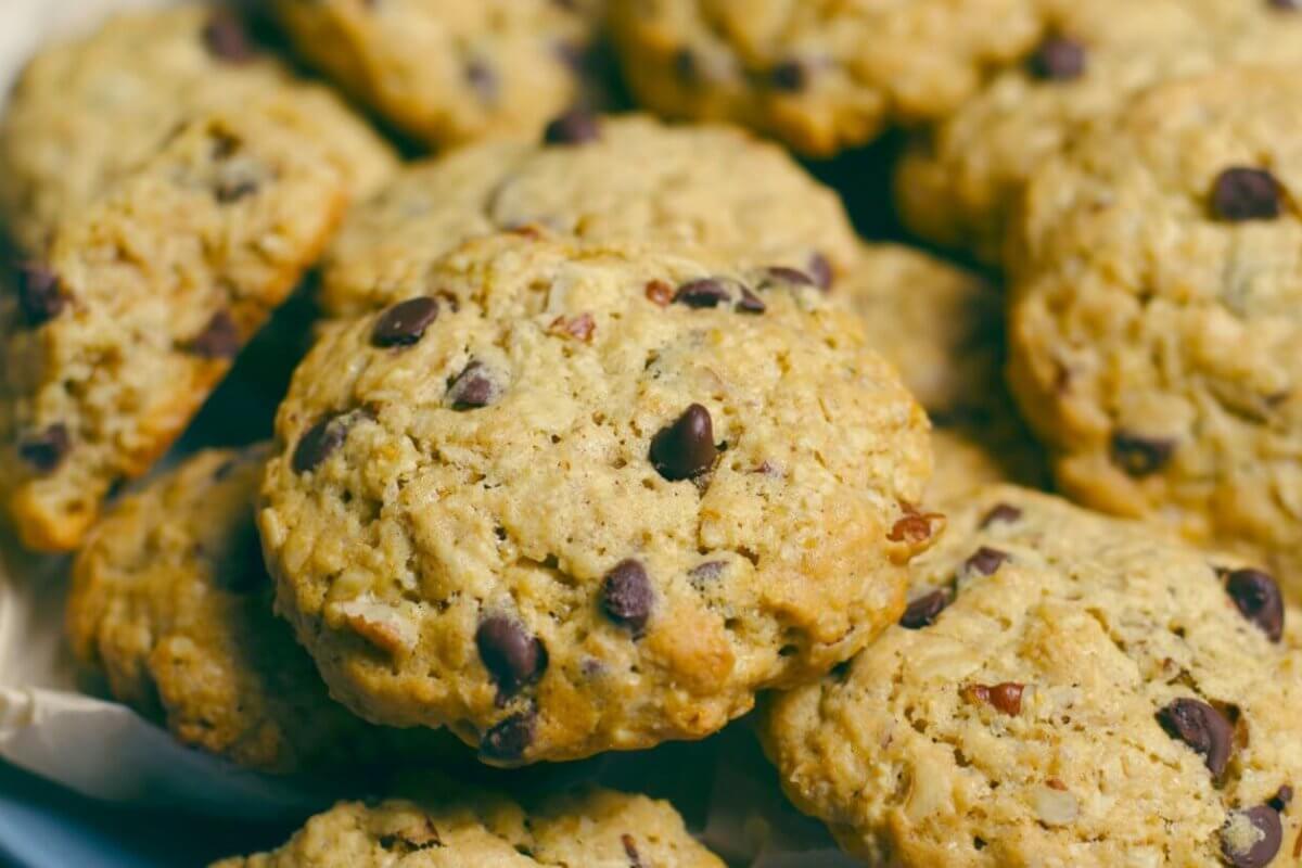 A close-up image of freshly baked chocolate chip cookies from one of Metro Manila's best cookie places, with golden edges and visible chocolate chunks, arranged on a plate lined with parchment paper.
