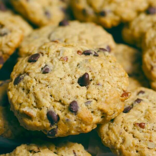 A close-up image of freshly baked chocolate chip cookies from one of Metro Manila's best cookie places, with golden edges and visible chocolate chunks, arranged on a plate lined with parchment paper.
