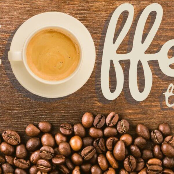 A white cup of coffee sits on a wooden surface, surrounded by scattered coffee beans. The words "it's coffee time!" are artistically written in beige lettering around the cup. The composition creates a cozy and inviting atmosphere that celebrates Antipolo's best coffee shops.