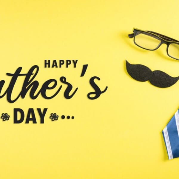 A bright yellow background showcases a pair of black glasses, a black mustache cutout, and a blue and white striped necktie. The bold, black text reads "Happy Father's Day" with small decorative floral elements on either side. Perfect for heartfelt messages or gift ideas to make the day special.
