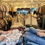 Colorful racks and tables of secondhand clothing at a Philippine ukay-ukay thrift shop
