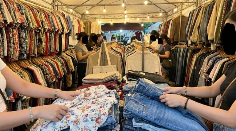 Colorful racks and tables of secondhand clothing at a Philippine ukay-ukay thrift shop