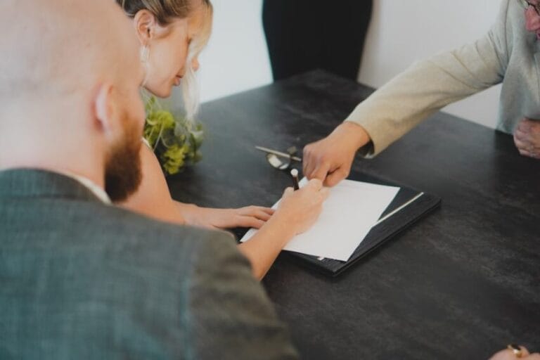 Couple signing a membership contract at a desk during a vacation club sales presentation in the Philippines