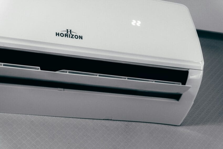 Wall-mounted split-type air conditioner unit in a Philippine home, the kind of appliance covered in this repair-vs-replace cost breakdown