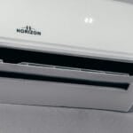 White split-type inverter air conditioner unit mounted on a wall, displaying a 22-degree temperature setting, the type of unit compared to non-inverter aircons in this Philippine buying guide