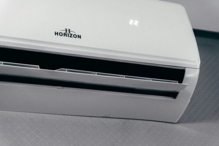 White split-type inverter air conditioner unit mounted on a wall, displaying a 22-degree temperature setting, the type of unit compared to non-inverter aircons in this Philippine buying guide