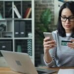 Woman paying for an online purchase with a credit card and smartphone, representing a Buy Now, Pay Later checkout used by SPayLater, Lazada PayLater, GCredit, and Maya Easy Credit in the Philippines