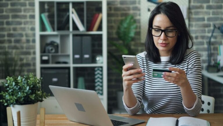 Woman paying for an online purchase with a credit card and smartphone, representing a Buy Now, Pay Later checkout used by SPayLater, Lazada PayLater, GCredit, and Maya Easy Credit in the Philippines