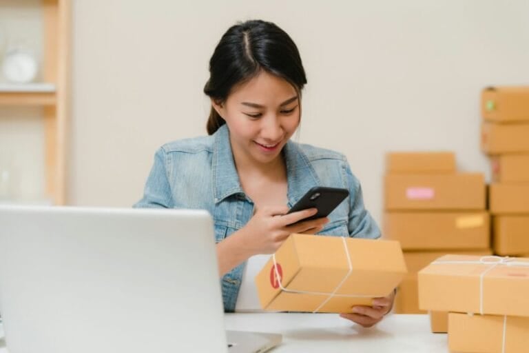 Filipino online shopper scanning a delivered product against her phone to verify it before trusting the platform — illustrating the Shopee, Lazada, TikTok Shop, Carousell, and Facebook Marketplace buyer protection comparison