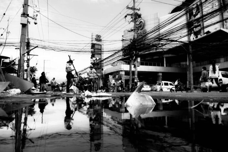 Flooded residential street in Lapu-Lapu City, Cebu, Philippines after a typhoon, the kind of calamity that automatically triggers DTI's price freeze on basic necessities