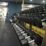 Rack of dumbbells in a commercial gym, representing the weight-training equipment members pay monthly gym membership fees to access in the Philippines