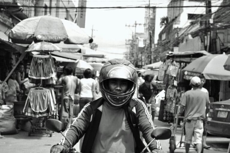 Commuter riding a motorcycle through Metro Manila traffic, the kind of everyday motorcycle purchase decided with financing in the Philippines