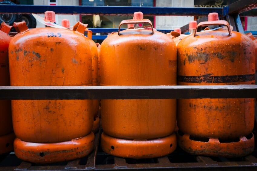 Stacked orange LPG gas cylinder tanks, the type exchanged palit-tangke style at dealers in the Philippines