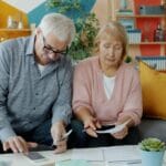 Is a PERA (Personal Equity and Retirement Account) Worth It in the Philippines? (2026 Guide) Senior Filipino couple reviewing retirement savings and financial papers at home, deciding whether to open a PERA account