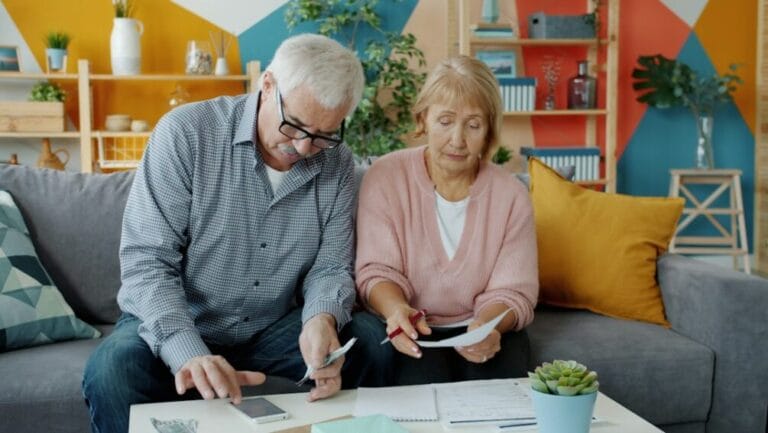 Senior Filipino couple reviewing retirement savings and financial papers at home, deciding whether to open a PERA account
