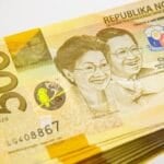 Philippine 5000-peso banknote on a table, representing the choice between Pag-IBIG MP2 savings and a bank time deposit