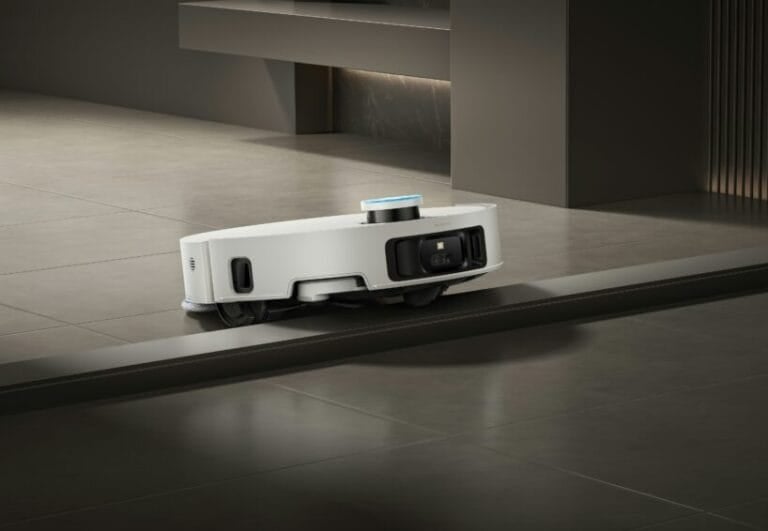 Dreame robot vacuum and mop climbing over a tile floor threshold, illustrating how robot vacuums handle common obstacles in Philippine homes