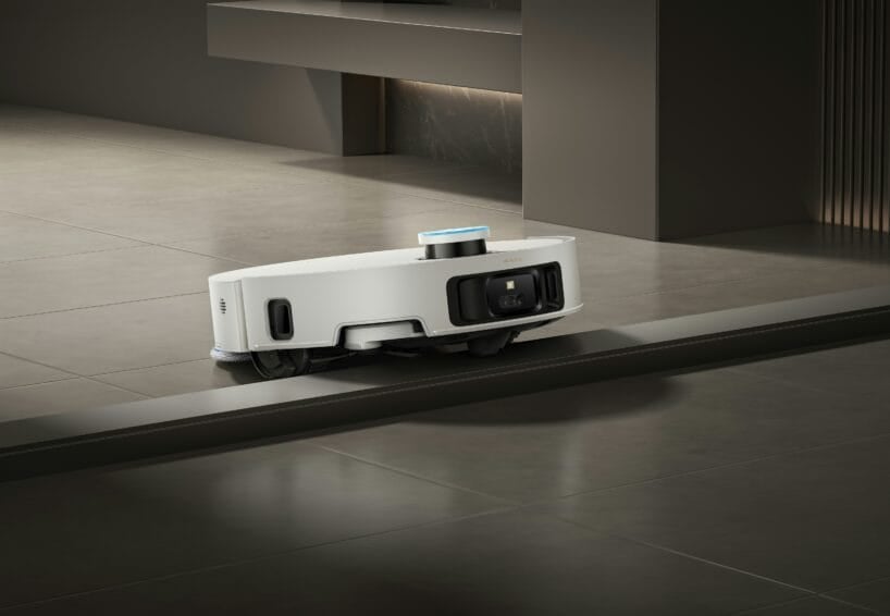 Dreame robot vacuum and mop climbing over a tile floor threshold, illustrating how robot vacuums handle common obstacles in Philippine homes