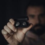 Close-up of a hand holding wireless ANC (active noise-cancelling) earbuds, the Jabra Elite 85t, the product type covered in this Philippine buying guide