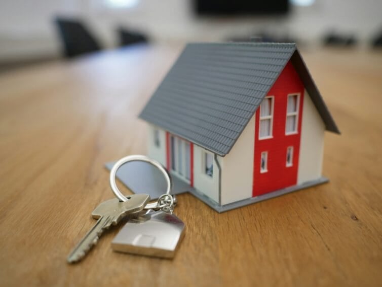 A set of house keys left on a table for a short-term rental handover in the Philippines, illustrating the self-check-in style of an Airbnb booking compared to a staffed hotel front desk