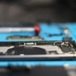 Technician disassembling an iPhone to replace parts, the kind of repair work an Apple Authorized Service Provider in the Philippines must document and warranty