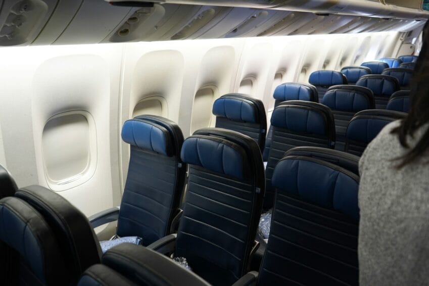 Rows of empty economy airplane seats, illustrating the paid seat-selection decision on AirAsia and Cebu Pacific budget flights in the Philippines