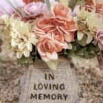 Fresh flowers laid on a cemetery grave, representing the cost comparison between traditional burial, memorial lots, and cremation in the Philippines