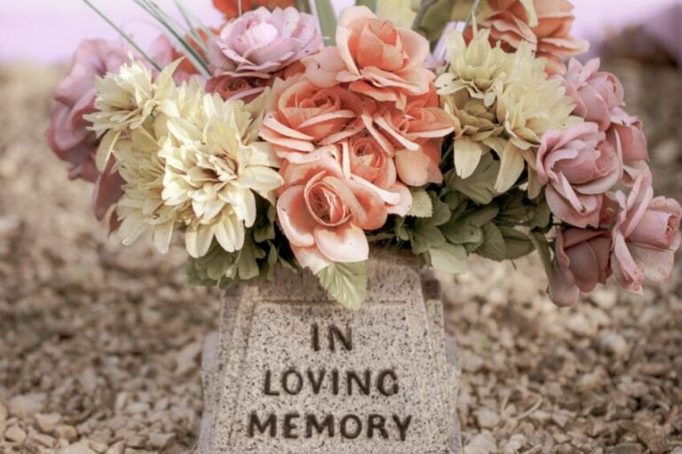 Fresh flowers laid on a cemetery grave, representing the cost comparison between traditional burial, memorial lots, and cremation in the Philippines