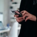 Person using a mobile phone to place a call