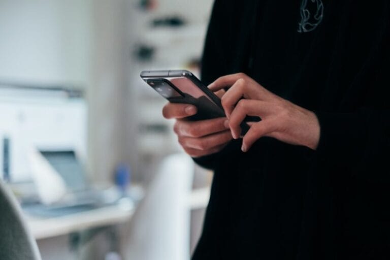 Person using a mobile phone to place a call