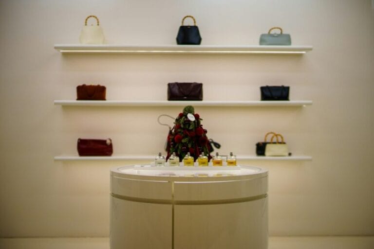 Designer handbags displayed on illuminated retail shelves, illustrating the gap between authentic bags and "Class A" replicas sold online in the Philippines