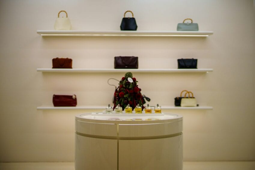 Designer handbags displayed on illuminated retail shelves, illustrating the gap between authentic bags and "Class A" replicas sold online in the Philippines