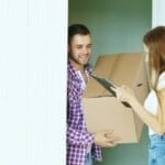 Courier delivering a cardboard parcel to a customer at home, representing padala and courier delivery services in the Philippines