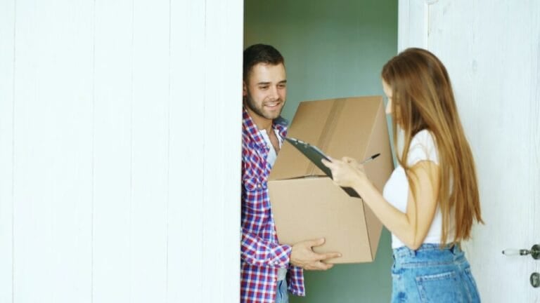 Courier delivering a cardboard parcel to a customer at home, representing padala and courier delivery services in the Philippines
