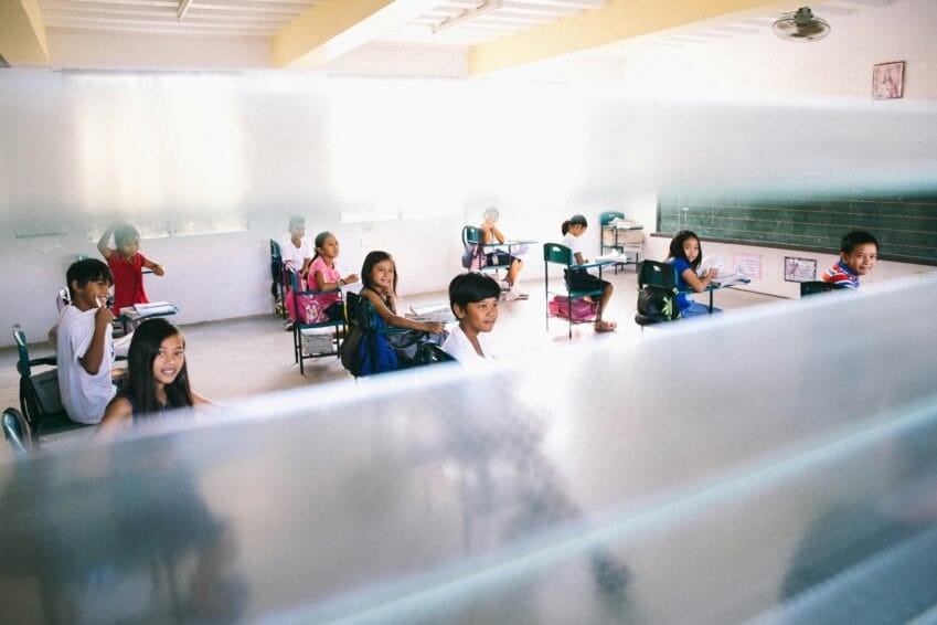 Open coworking space with shared desks and laptops where freelancers and remote workers in the Philippines can rent a seat