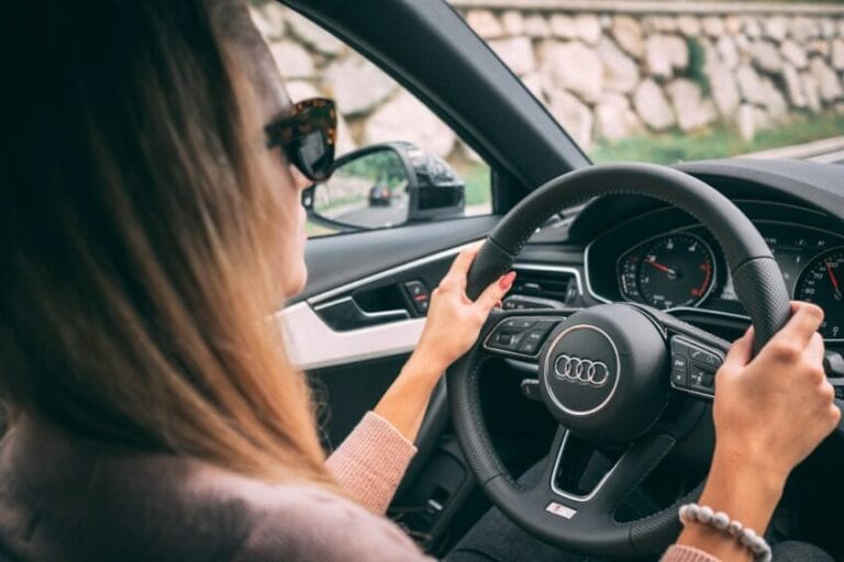 Hands gripping a car's steering wheel while driving, representing the LTO-mandated Practical Driving Course (PDC) new license applicants in the Philippines must complete