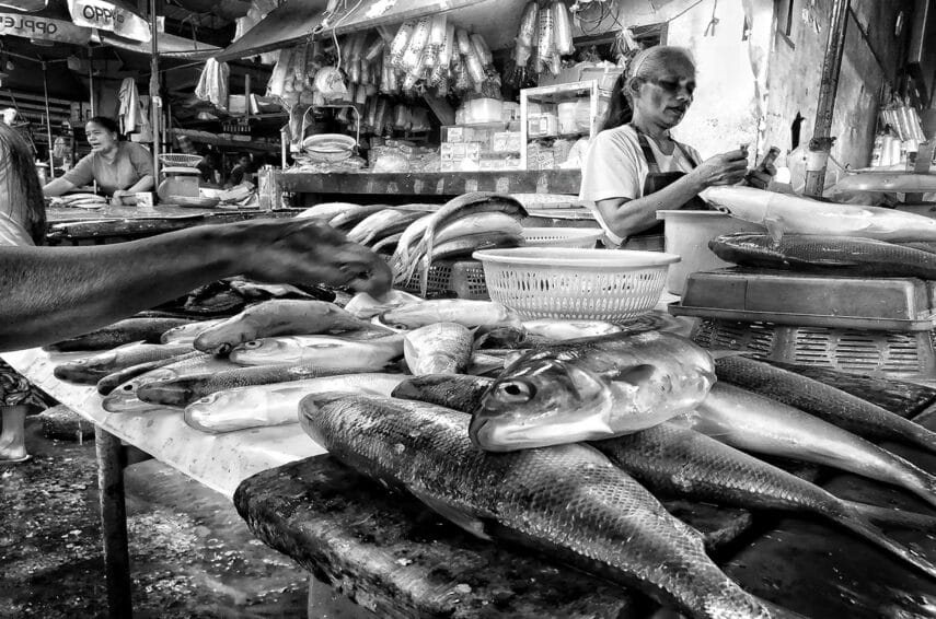 Inside a Philippine palengke (wet market) in Balintawak, Quezon City, with vendor stalls selling fresh produce