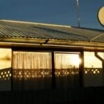 A satellite dish mounted on a home's corrugated roof for satellite internet service, used to illustrate whether Starlink is worth it in the Philippines